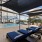 shaded lounge chairs next to outdoor swimming pool